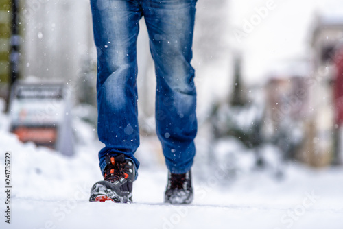 Man walking on snowy sidewalk