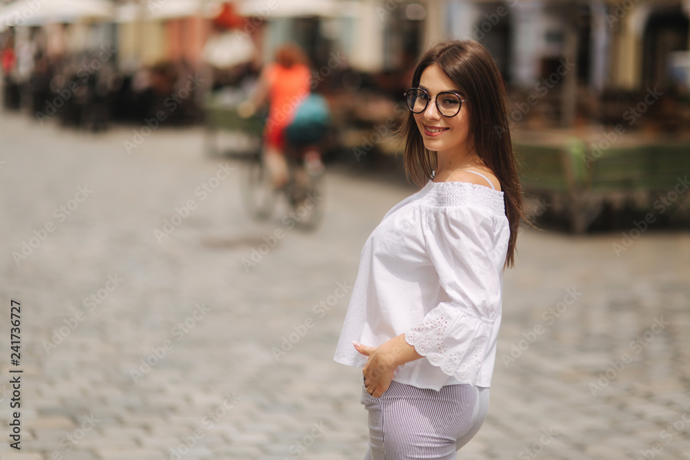 Fototapeta premium Attractive young lady stand in centre of the city