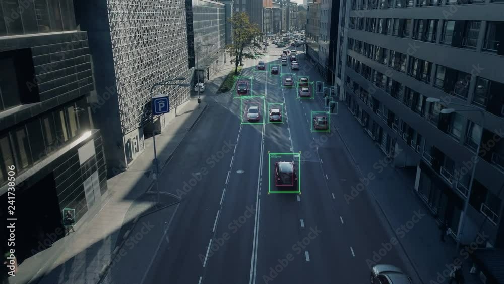 Aerial Drone Shot: Autonomous Self Driving Cars Moving Through City. Concept: Artificial Intelligence Scans Cars and Pedestrians, Following Movement and Showing Data.