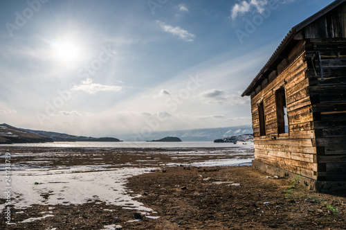 Old wooden abandoned house on the shore of Baikal lake, Siberia