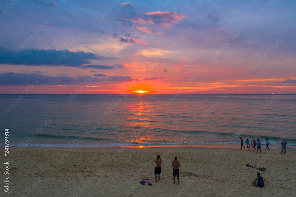stunning sunset over coconut trees at Karon beach Phuket