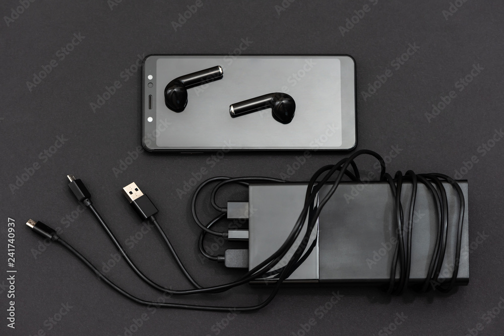 Still life with a smartphone, headphones and power bank. Still life with a smartphone, headphones and power bank.