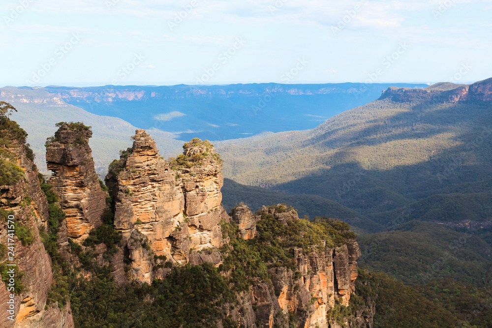 View of the Three Sisters in Katoomba with a valley of the Blue Mountains in the background (Sydney, New South Wales, Australia)