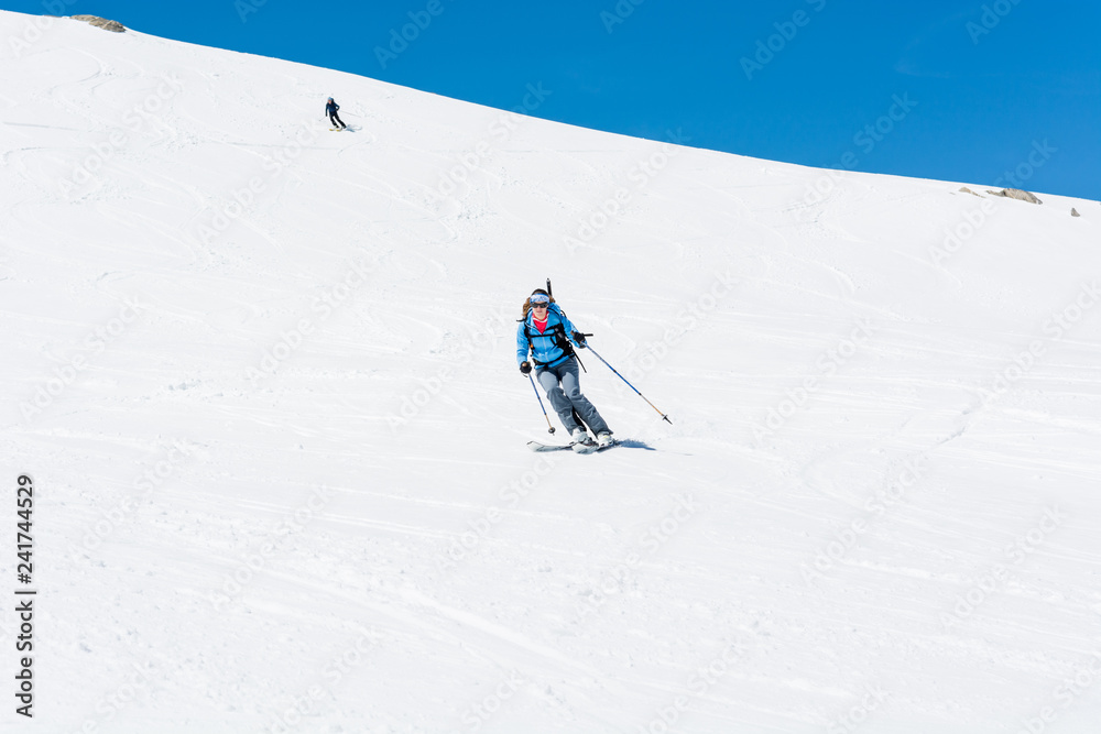 Female back-country skier tackling a steep slope.