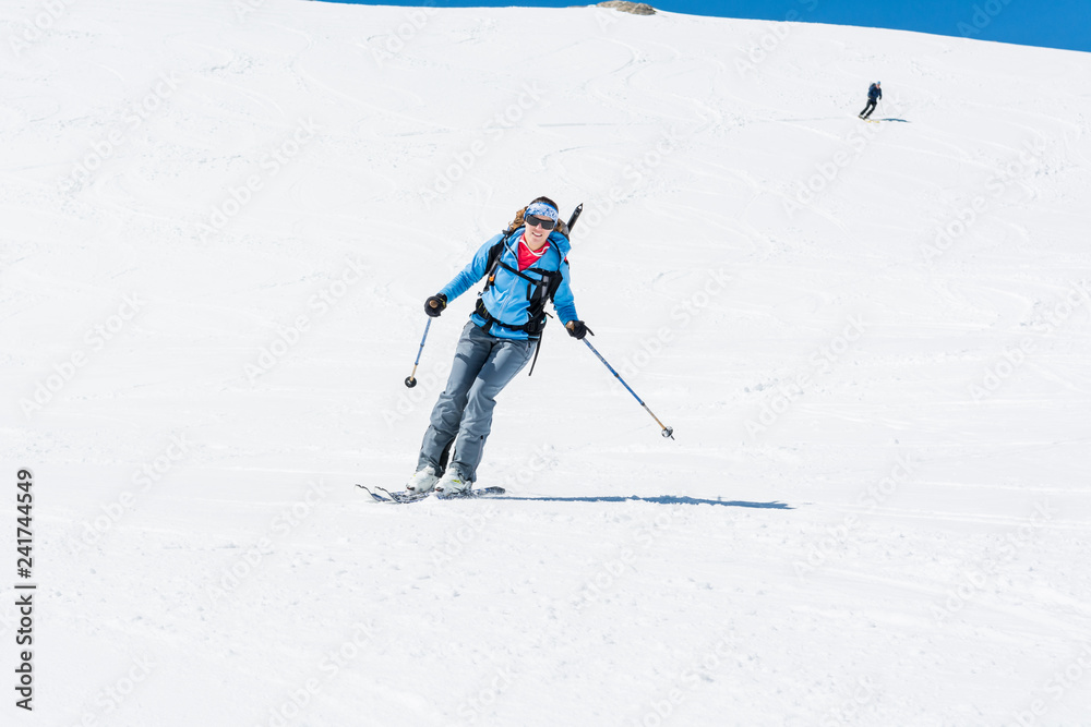 Female back-country skier tackling a steep slope.