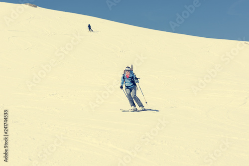 Female back-country skier tackling a steep slope.