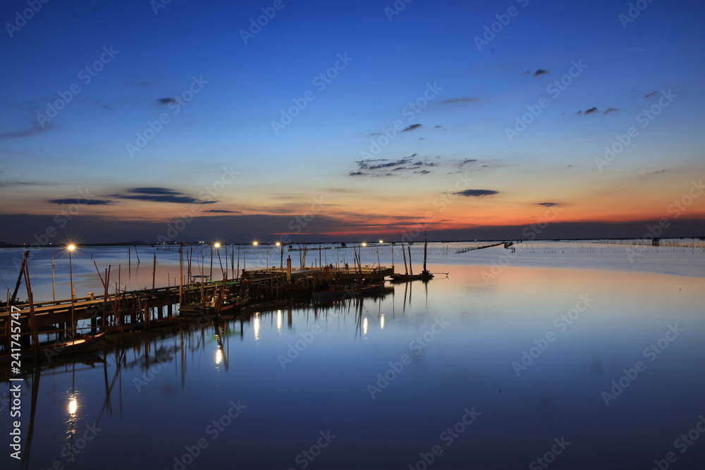 landscape or nature view of old fisherman bridge over to sea with blue sky during twilight time in Chonburi Province, Thailand