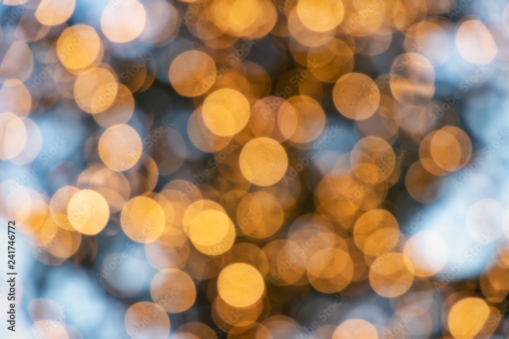 Fototapeta premium Blue and yellow Christmas lights defocused