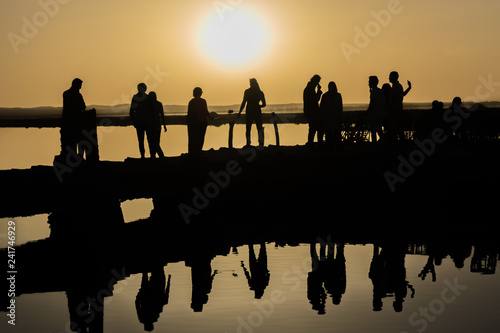 Silhouette and Reflection on calm water in Fatnas Island , Siwa Egypt