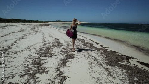 Joyful happy woman walking on seashore of white sand in popolar Hangover Bay, Cervantes, Nambung National Park, Western Australia. Blonde girl happiness walk. Copy Space photo
