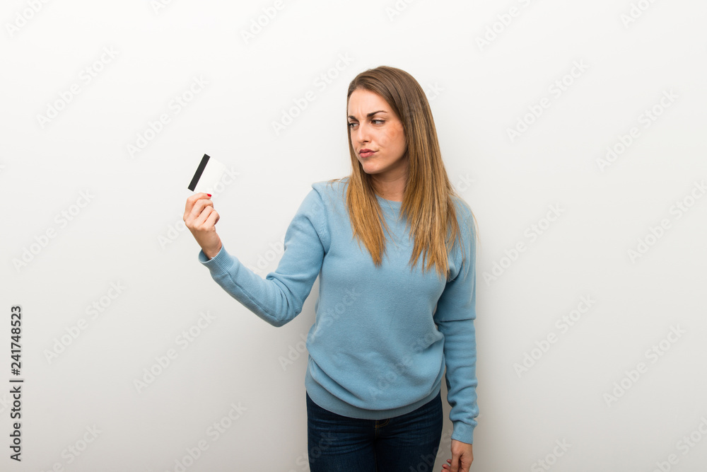 Blonde woman on isolated white background taking a credit card without money Blonde woman on isolated white background taking a credit card without money