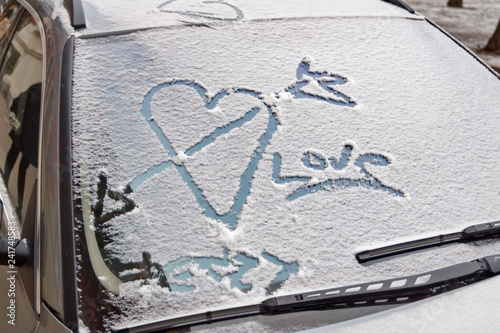 valentines day graffiti in snow on windscreen of car