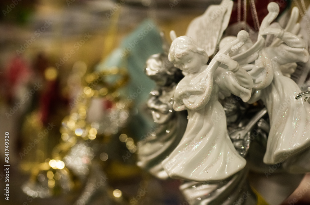Sale of Christmas toys in the supermarket. Ceramic angel - New Year's toy. 