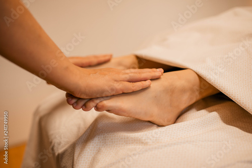 Beautiful woman having a relaxing foot massage in the spa beauty salon. Body care