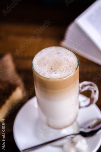 Glass latte with a book in the background
