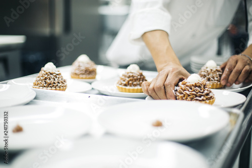 Chef sorting desserts on the plates