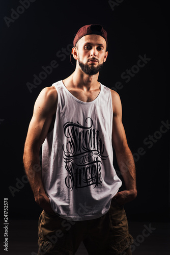 Portrait of a bearded man a hip hop dancer or bboy in urban style clothes and with inscription 