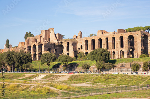 View of the Circus Maximus terrain and the ruins of the Temple of Apollo Palatinus in Rome, Italy. Shot in afternoon sunlight and set against a clear blue sky. 