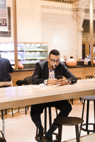 Man using smartphone while sitting in a cafe