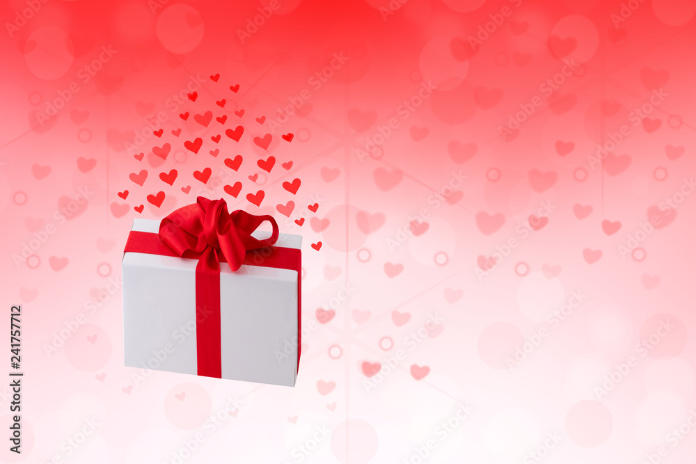 Happy Valentines or wedding day. Abstract love romantic holiday red background with hearts and a gift box with red ribbon. Template with space fro your design.