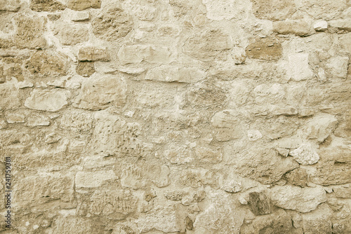 Old beige stone wall background texture