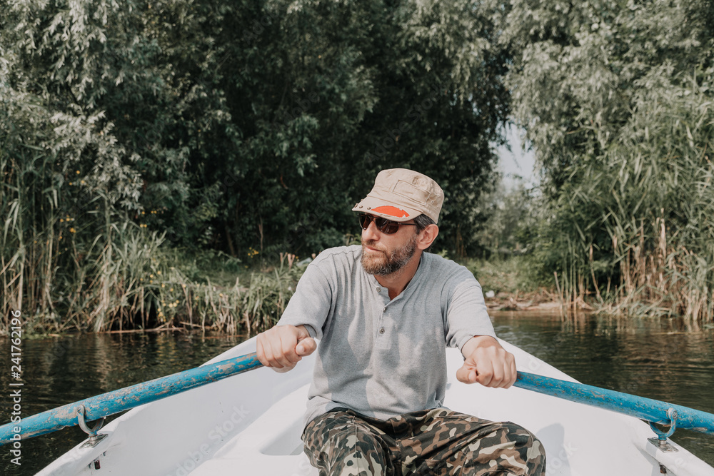 man with beard rowing on rowing boat man with beard rowing on rowing boat