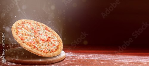 classic pizza on a dark wooden table background and a scattering of flour. pizza restaurant menu concept