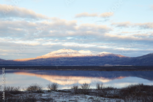 Thingvallavatn lake with reflection of sun during winter near sunrise