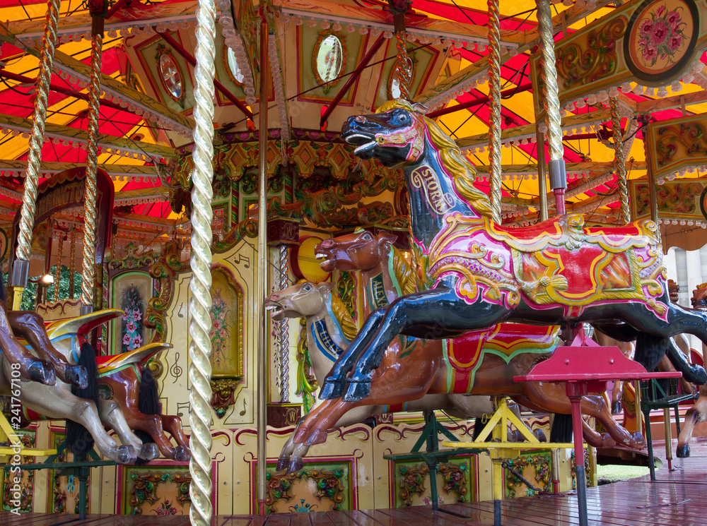 Close up of colorful carousel horses in the park