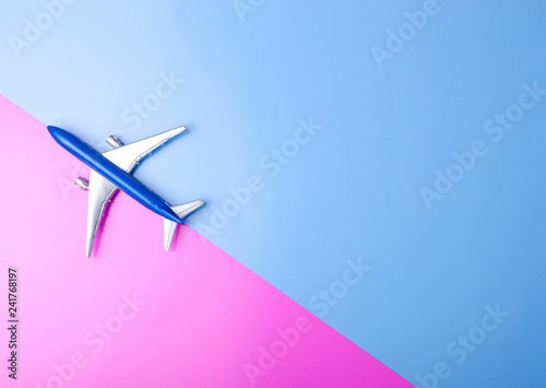 Blue model plane,airplane on color pink blue background, top view