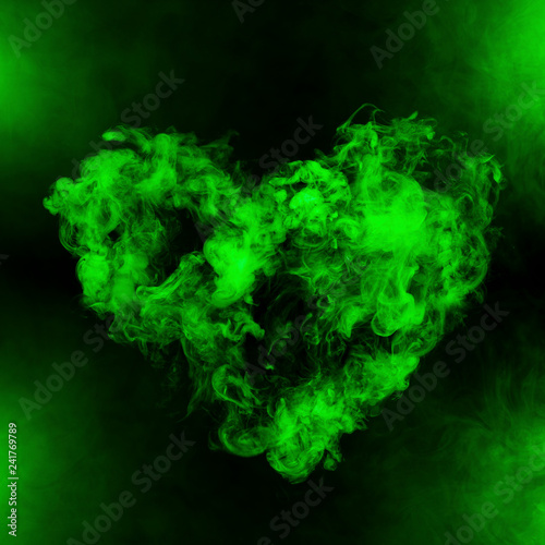 heart shape from green smoke isolated on black background