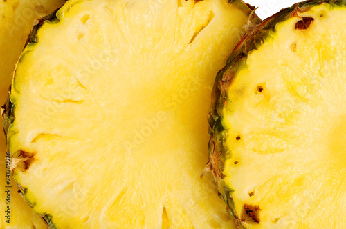 Pineapple circles closeup, background. Texture is brightly expressed. A good solution for design.