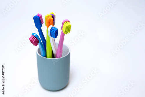 Colorful toothbrushes on a light background