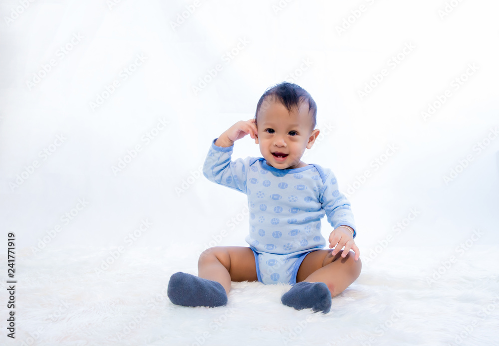 smile baby boy is shooting in the studio. fashion image of baby and family. Lovely baby sit down on a soft white carpet. image for background, wallpaper, copy space, objects, fashion and article smile baby boy is shooting in the studio. fashion image of baby and family. Lovely baby sit down on a soft white carpet. image for background, wallpaper, copy space, objects, fashion and article