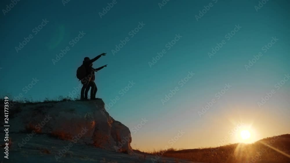 Teamwork victory tourists. two men tourists hiking adventure climbers climb the mountain success freedom up. slow motion video. hiker walking goes on nature on the hill white rock. extreme lifestyle Teamwork victory tourists. two men tourists hiking adventure climbers climb the mountain success freedom up. slow motion video. hiker walking goes on nature on the hill white rock. extreme lifestyle