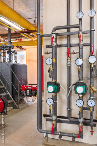 interior of industrial, gas boiler room with boilers; pumps; sensors and a variety of pipelines
