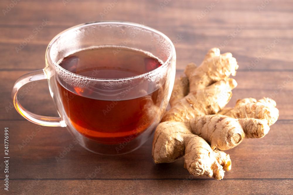 Cup of Ginger Root Tea on a Wooden Table Cup of Ginger Root Tea on a Wooden Table
