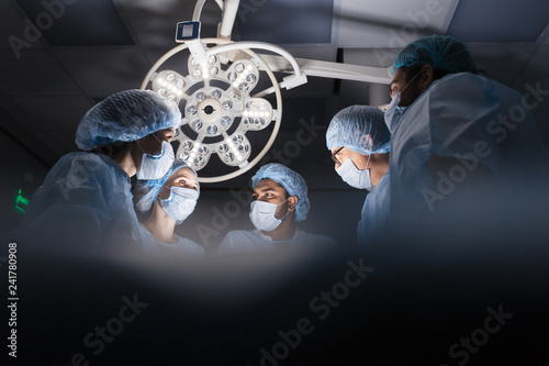 Professional Medical Surgeons Performing Surgery, bottom view.