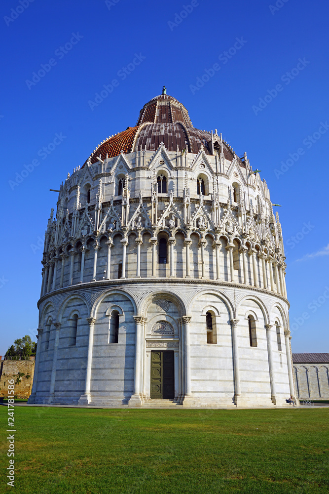 View of the Pisa Baptistery of St. John (Battistero di San Giovanni) on the Square of Miracles (Piazza dei Miracoli) complex near the Leaning Tower of Pisa in Tuscany
