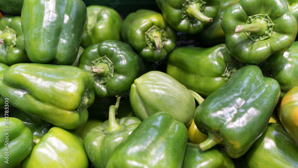 Green fresh bell pepper or capsicum in the market used for your pattern or your background design. Food and healthy care concept Green fresh bell pepper or capsicum in the market used for your pattern or your background design. Food and healthy care concept