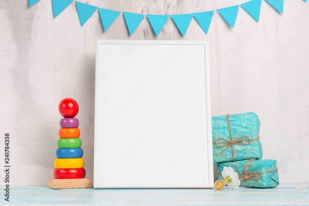 Children's toys, with a white frame The frame on a light background of the wall with children's signs, for design, layout. Baby shower