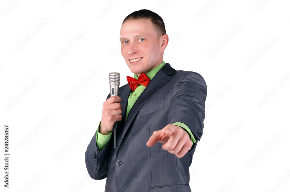 Happy presenter or businessman with microphone in the hands is showing ahead by his index finger isolated on white background. Happy presenter or businessman with microphone in the hands is showing ahead by his index finger isolated on white background.