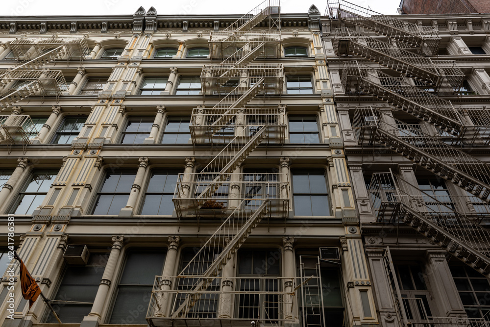 New York city old building in soho with the metal external fire escape stairs of the Manhattan old buildings