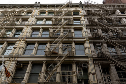 New York city old building in soho with the metal external fire escape stairs of the Manhattan old buildings © Filippo