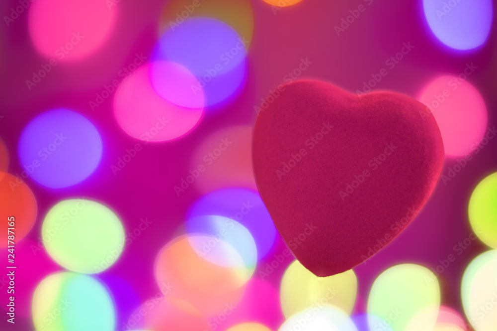 Red heart on blurred background, festive background for Valentine's day