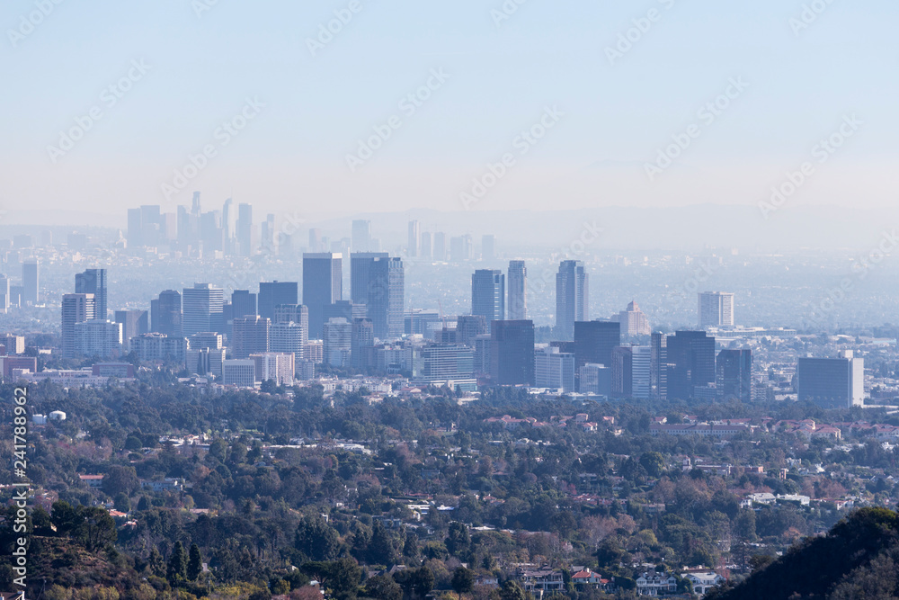 Smoggy morning cityscape view towards Century City and downtown Los Angeles from hiking trail in the Santa Monica Mountains.  