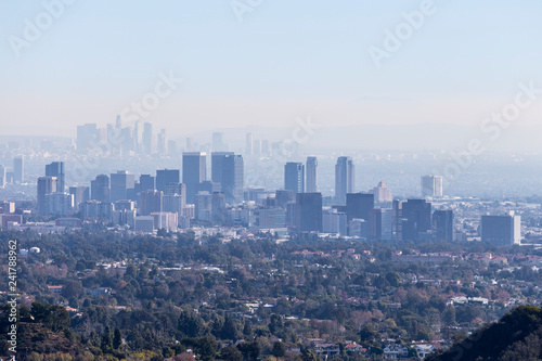 Smoggy morning cityscape view towards Century City and downtown Los Angeles from hiking trail in the Santa Monica Mountains. 