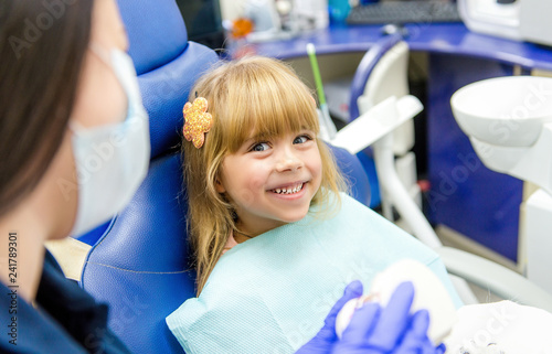 Little girl sitts in the dentist's office