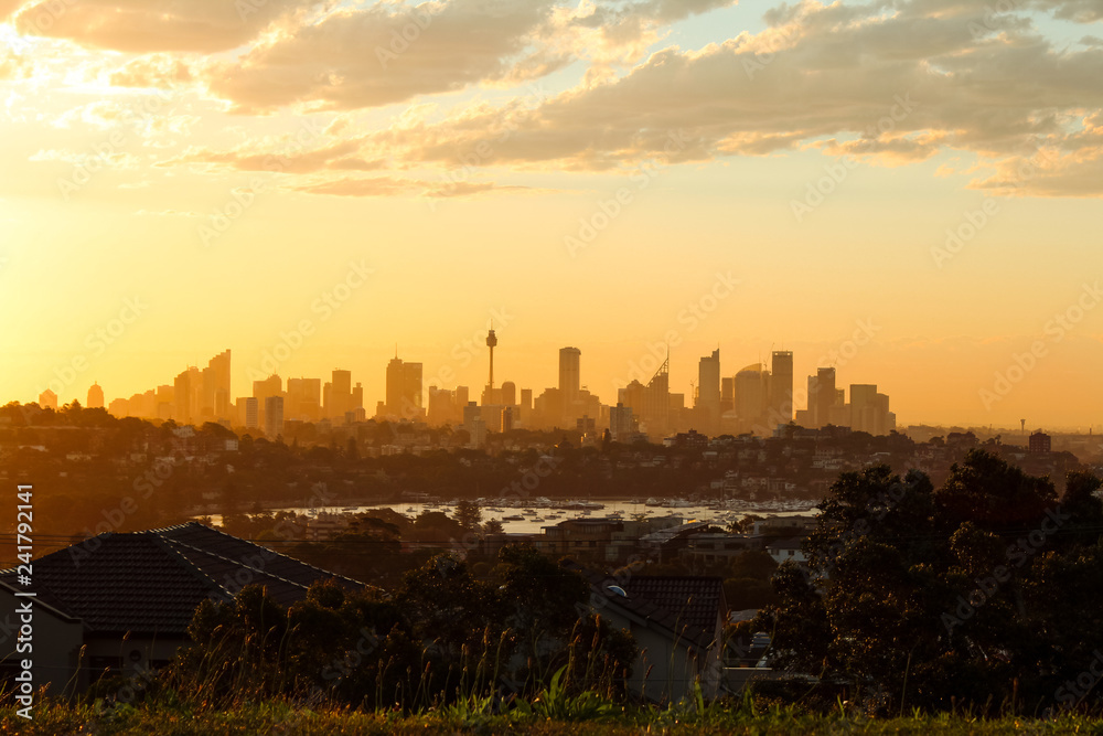 Magical glowing orange sunset over the skyline of Sydney as seen on a summer evening from Dover Heights (Sydney, Australia)