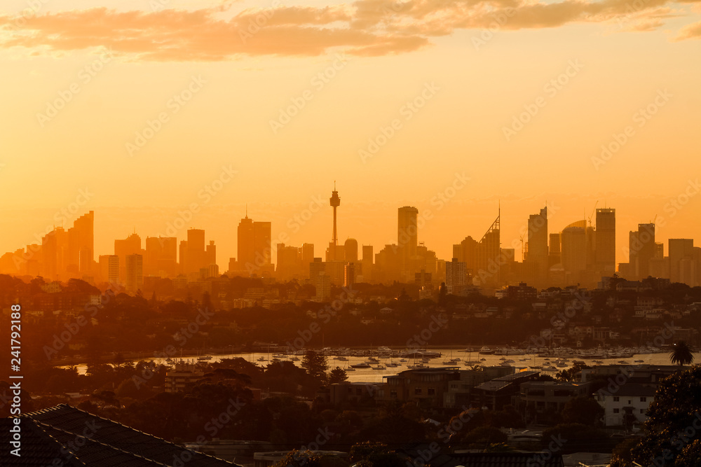 Close up of magical glowing orange sunset over the skyline of Sydney as seen on a summer evening from Dover Heights (Sydney, Australia)